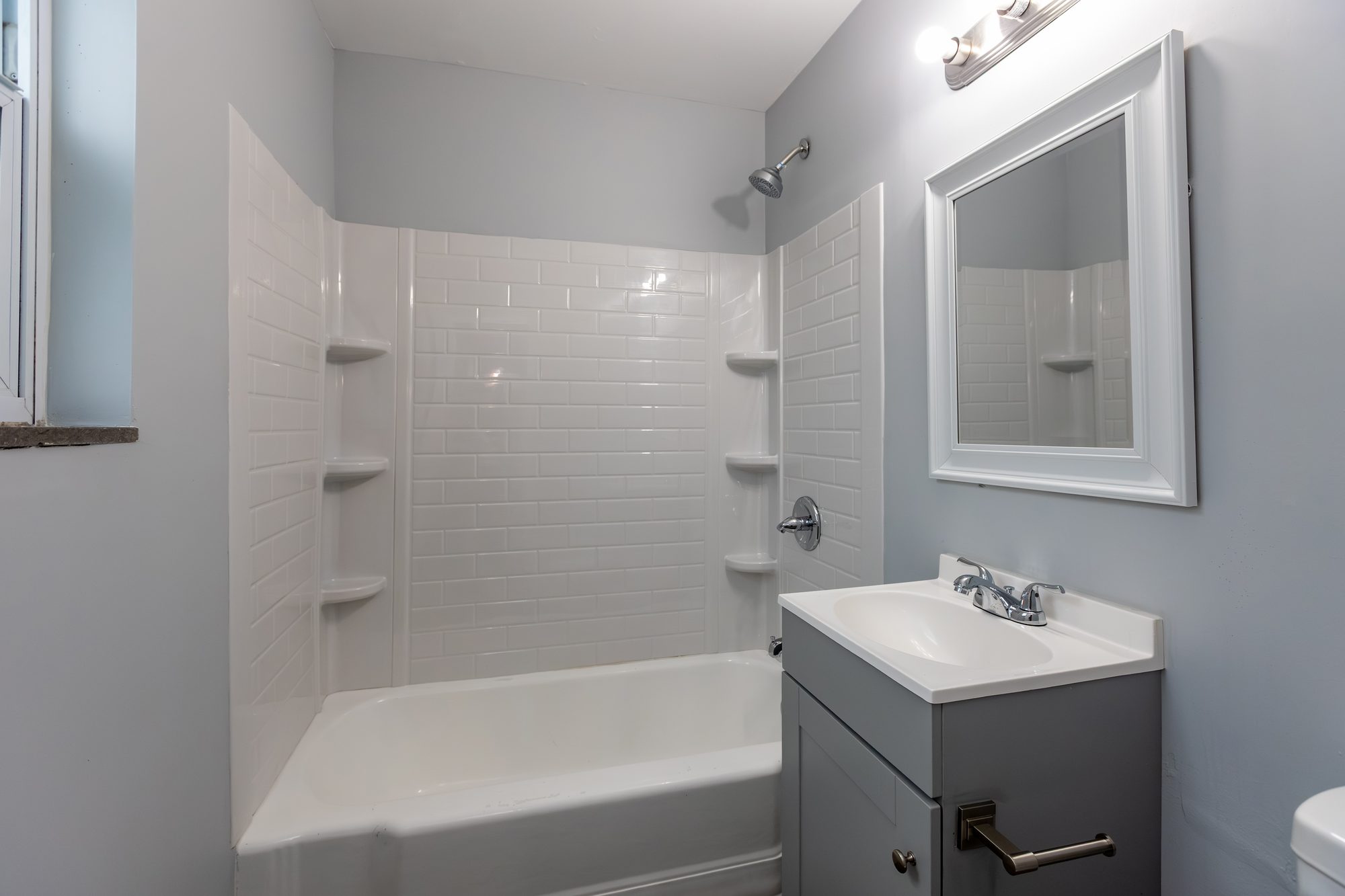 Newly renovated bathroom with clean tilework and a modern vanity at Cleve Royale Apartments